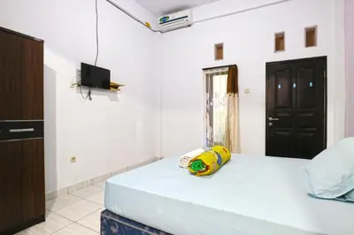 a bedroom with a bed with a toy on it at Micost Homestay in Denpasar