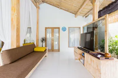 a living room with a couch and a flat screen tv at Villa Orked 1 in Seminyak