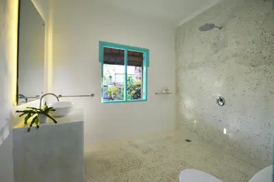a bathroom with a sink and a window at Villa Zenta in Canggu