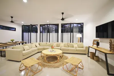 a living room with a couch and a table at Villa Zenta in Canggu