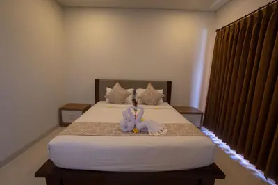 a bedroom with a bed with a stuffed animal on it at Juada Garden in Seminyak