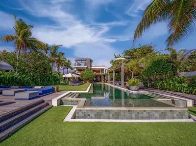 an exterior view of a villa with a swimming pool at Noku Beach House by Elite Havens in Seminyak