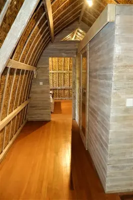 an attic hallway with wood floors and a vaulted ceiling at Villa Made East in Seminyak