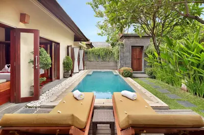 a swimming pool in the backyard of a house at Nyuh Bali Villas in Seminyak