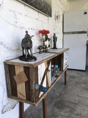 a wooden table with a statue on top of it at Villa Dea in Nusa Dua