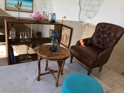 a living room with a chair and a coffee table at Villa Dea in Nusa Dua