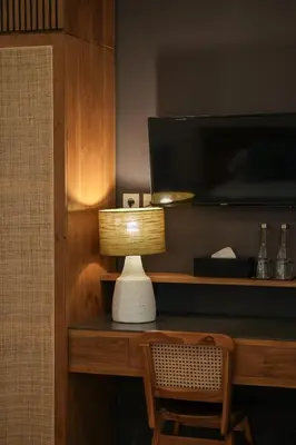 a lamp sitting on a desk next to a television at Villa Artisane in Seminyak