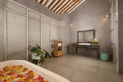 a bathroom with a sink and a mirror at Villa Hasian Jimbaran in Jimbaran