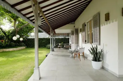 a patio with awning and chairs on a house at Villa Hasian Jimbaran in Jimbaran