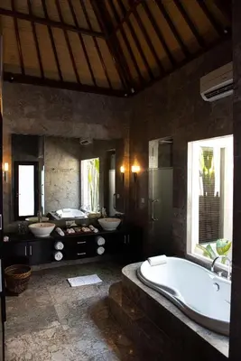 a large bathroom with two sinks and a bath tub at My Villas In Bali in Seminyak