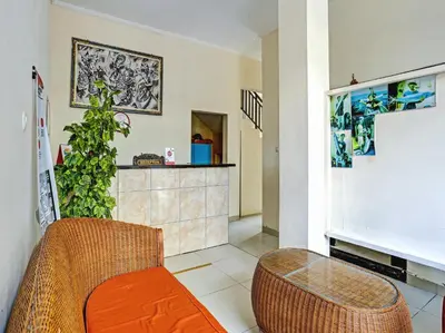 a living room with a couch and a table at Samudra Homestay in Kuta