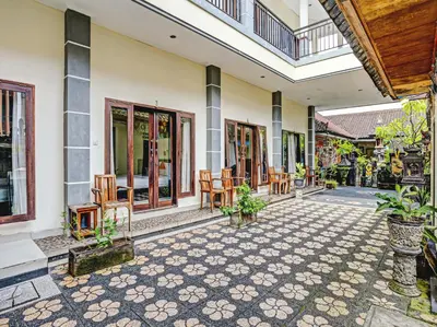 a courtyard of a house with chairs and tables at Samudra Homestay in Kuta