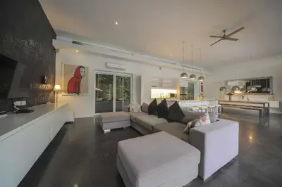 a living room with a couch and a table at Casa Priya Petitenget in Seminyak