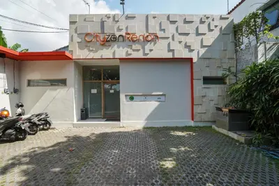 a building with a garage with a sign on it at Cityzen Renon Hotel in Denpasar