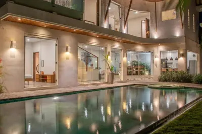 a house with a swimming pool in the yard at Villa K-Mea in Seminyak