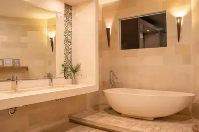 a bathroom with a large tub and two sinks at Villa K-Mea in Seminyak