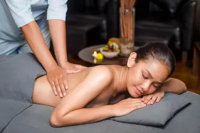 a woman getting a massage from a therapist at THE 1O1 Bali Fontana Seminyak in Legian