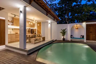 an indoor swimming pool in the backyard of a house at The Lagoon Canggu in Canggu