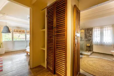 a hallway with a wooden door in a room at Oma Villa - A tropical sanctuary of Seminyak in Seminyak
