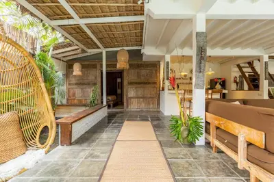 an outdoor seating area with benches and a table at Oma Villa - A tropical sanctuary of Seminyak in Seminyak