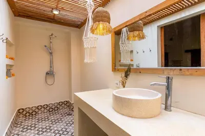 a bathroom with a sink and a shower at Oma Villa - A tropical sanctuary of Seminyak in Seminyak