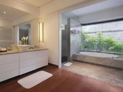 a bathroom with a tub and a large window at Peppers Seminyak in Seminyak