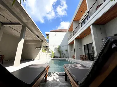 a swimming pool in the backyard of a house at Adi surya guest house in Seminyak