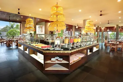 a restaurant with a buffet of food on display at Legian Beach Hotel in Legian