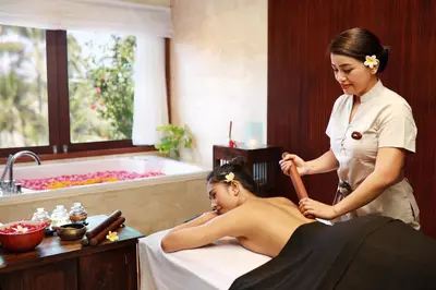 a woman getting a massage in a hotel room at Legian Beach Hotel in Legian