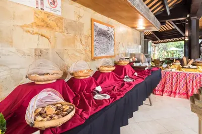 a row of tables with baskets of food on them at Hotel Vila Lumbung in Seminyak