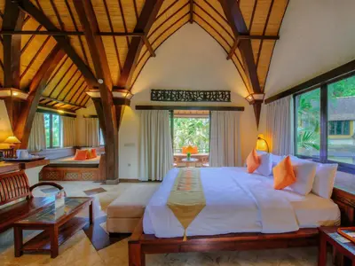 a bedroom with a large bed in a room at Hotel Vila Lumbung in Seminyak