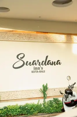 a sign for santander incs hotel mall at Suardana Inn's in Kuta