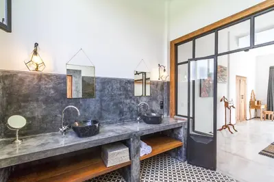 a bathroom with two sinks and two mirrors at Villa Maje by Alfred in Bali in Seminyak