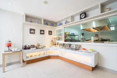 a large kitchen with a counter in a room at Alron Hotel Kuta in Kuta