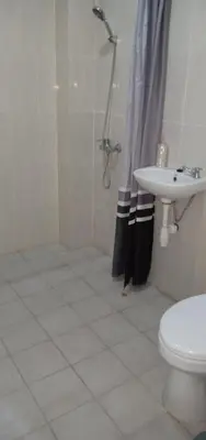 a bathroom with a shower and a toilet and a sink at Alamanda Villa in Seminyak