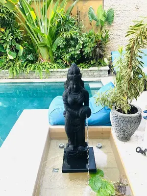 a statue in a fountain next to a pool at 3BR Villa Carissa Seminyak Centre, Bali by Le Ciel Hospitality in Seminyak