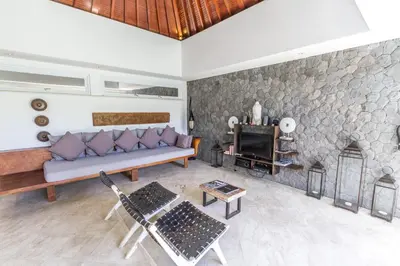 a living room with a couch and a fireplace at Vishuddha Ajna Villa - Outstanding 2 bdr villa - GREAT LOCATION! in Seminyak