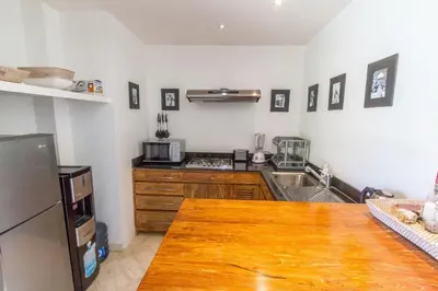 a kitchen with a wooden counter top and a refrigerator at Vishuddha Ajna Villa - Outstanding 2 bdr villa - GREAT LOCATION! in Seminyak
