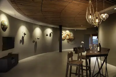 a room with a table and chairs and a chandelier at Dacolina House in Jimbaran
