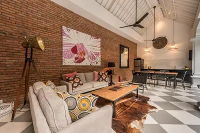 a living room with a couch and a brick wall at Central 3 Bedroom Villa close to Seminyak Beach in Seminyak