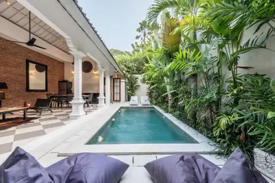 an indoor swimming pool in a house with plants at Central 3 Bedroom Villa close to Seminyak Beach in Seminyak
