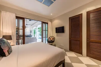 a bedroom with a large white bed and a window at Central 3 Bedroom Villa close to Seminyak Beach in Seminyak