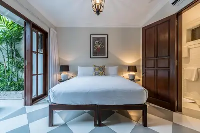 a bedroom with a large bed and two lamps at Central 3 Bedroom Villa close to Seminyak Beach in Seminyak