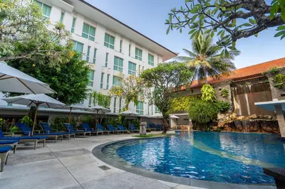 a swimming pool in front of a hotel at Bintang Kuta Hotel in Kuta