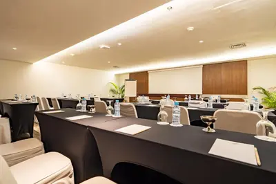 a conference room with long tables and chairs at Bintang Kuta Hotel in Kuta