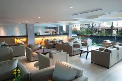 a lobby with couches and chairs and a fireplace at Bintang Kuta Hotel in Kuta