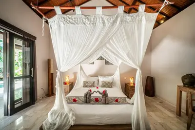 a bedroom with a canopy bed with white drapes at Villa Koala, 2Br Close to W, Potato Head and Shi Shi in Seminyak