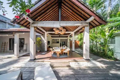 an outdoor dining area with a wooden pergola at Villa Koala, 2Br Close to W, Potato Head and Shi Shi in Seminyak