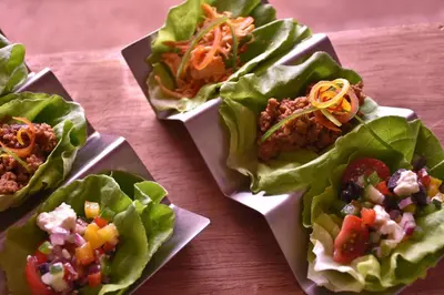a group of four lettuce wraps on a table at The Stones Hotel - Legian Bali in Kuta