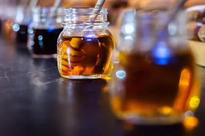 a mason jar of honey sitting on a table at The Stones Hotel - Legian Bali in Kuta